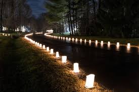 Lined candle luminaries lighting a path at night